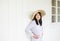 Portrait of beautiful asian woman wearing hat and standing at home,Positive thinking,Good attitude