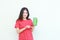 portrait of beautiful asian woman wearing red outfit celebrating Indonesia independence day by gesturing holding mobile phone