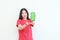 portrait of beautiful asian woman wearing red outfit celebrating Indonesia independence day by gesturing holding mobile phone