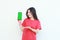 portrait of beautiful asian woman wearing red outfit celebrating Indonesia independence day by gesturing holding mobile phone