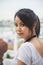 Portrait beautiful Asian woman in a white T-shirt looking at a camera at the Wat Arun temple while traveling in Thailand