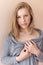 Portrait of beautiful attractive girls in a gray robe near the wall in the apartment in soft shades of vanilla