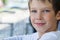 Portrait of a beautiful baby boy model in white clothes with a kind look,