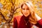 a portrait beautiful blonde against the background of autumn foliage