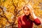 a portrait beautiful blonde against the background of autumn foliage