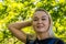 Portrait of a beautiful blonde in the park. Young pretty caucasian woman walking in a summer sunny day