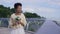 Portrait of beautiful bride admiring wedding bouquet dreaming looking away. Happy smiling African American loving woman