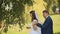 Portrait of a beautiful bride and handsome groom happy together in a birch grove. The groom comes to the bride behind