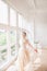 Portrait of beautiful bride indoor. Fashion bride girl in gorgeous wedding dress in studio