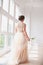 Portrait of beautiful bride indoor. Fashion bride girl in gorgeous wedding dress in studio.