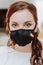 Portrait of a beautiful bride in a medical protective mask on her face. Wedding during the period of pandemic Covid-19
