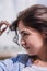 Portrait of a beautiful brunet girl touching her thick wavy hair