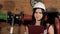 Portrait of a beautiful brunette Caucasian woman engineer. A woman inspector in a white hard hat against the background