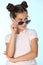 Portrait of a beautiful brunette child girl is looking cool with sunglasses, she looks away