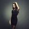 Portrait of beautiful brunette woman in black dress. Fashion photo