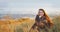 Portrait of the beautiful brunette woman at the windy autumn day