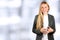 Portrait of beautiful business woman standing on a blue background