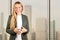 Portrait of beautiful business woman standing near windows