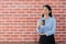 Portrait beautiful businesswoman holding coffee cup. standing in office distracted emotion sad face unhappy