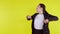 Portrait beautiful businesswoman in suit standing with glad and success isolated on yellow background.