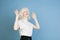 Portrait of beautiful caucasian albino girl isolated on blue studio background