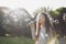 Portrait of a beautiful caucasian girl blowing soap bubbles in a meadow in a park