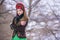 Portrait of Beautiful Caucasian Girl in Fashionable Green Dress and Kokoshnik with Flowery Pattern and Beads. Posing in Winter