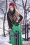 Portrait of Beautiful Caucasian Girl in Fashionable Green Dress and Kokoshnik with Flowery Pattern and Beads. Posing in Winter