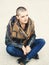 Portrait of beautiful Caucasian white young bald girl woman sitting on ground outside with shaved hair head