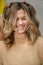 Portrait of Beautiful caucasian woman after coloring hair. Hairstylist puts fingers into models hair and makes her laugh.
