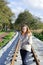 Portrait of beautiful caucasian woman wearing warm clothes and walking at railways - autumn