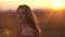 Portrait beautiful charming girl on sunset. Charming look of woman with long hair in sunset