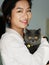 Portrait of beautiful Chinese young girl hug her cute British Shorthair Cat who has amazing orange eyes at home in sunny afternoon