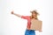 Portrait of beautiful country girl hitchhiking over white background.