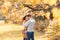 Portrait of beautiful couple man woman in love. Boyfriend and girlfriend hugging, smiling outdoor in park on a bright sunny autumn