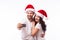 Portrait beautiful couple in Santa hats in love taking romantic self portrait