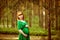 Portrait of a beautiful curly haired pregnant girl in a green dr