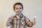 portrait of a beautiful cute caucasian blond boy with a toothbrush. Little boy brushing teeth and smiling while taking care of