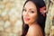 Portrait of beautiful dark-haired smiling girl against the backdrop of medieval stone buildings in the town of Altos de Chavon