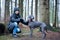 Portrait of a beautiful dog  blue Weimaraner breed  with a girl owner in nature, in full-length , the girl  looks at the camera