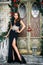 Portrait of beautiful elegant young woman in gorgeous evening dress over christmas background