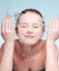 Portrait of beautiful emotional woman washing face