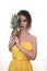 Portrait of a beautiful exsotic fashion girl brunette in the studio in a dress and a woth fruity - a pineapple