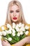 Portrait of beautiful fashion model with bouquet lily in hands, sweet and sensual. Beauty makeup, hair.