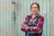 Portrait of beautiful female farmer in front of farmhouse shed