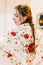 portrait of a beautiful female flamenco dancer looking down with a embroidered floral shawl on her back