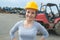 Portrait beautiful female wearing helmet in scrap yard