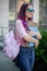 Portrait beautiful female writer dressed in casual outfit holding modern laptop in hand with backpack.