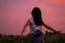 Portrait of beautiful freedom asian woman with holding medium format film camera with colorful sunset sky background