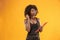 Portrait of a beautiful friendly African American woman with a curly afro hairstyle and red folder